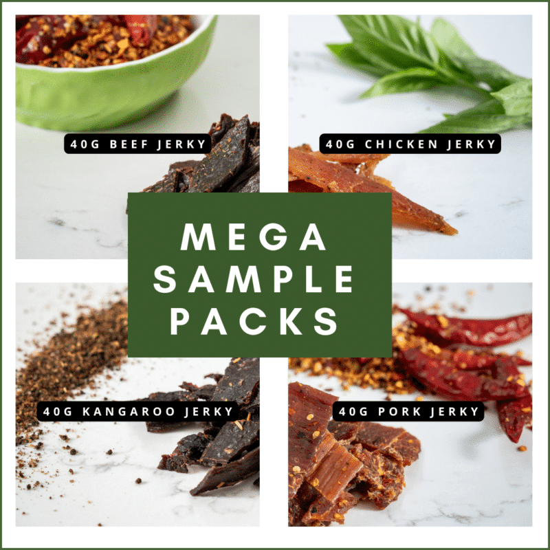 Sample packs of handcrafted chicken jerky, including curry, original, and butter flavors, displayed with herbs and spices.